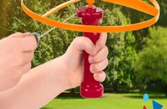 "Child playing with Battat Skyrocopter Flying Disc Toy under clear blue sky."